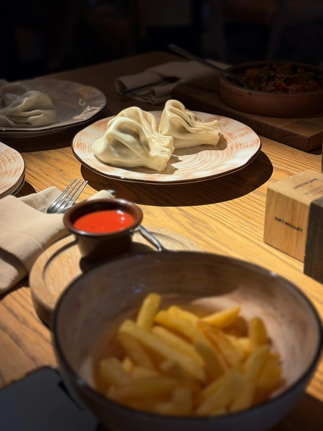 Table with traditional Polish dishes pierogi and soup in a cozy restaurant