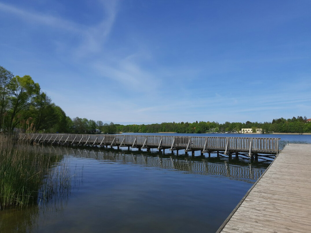Wooden pier on a calm Masurian lake at sunrise